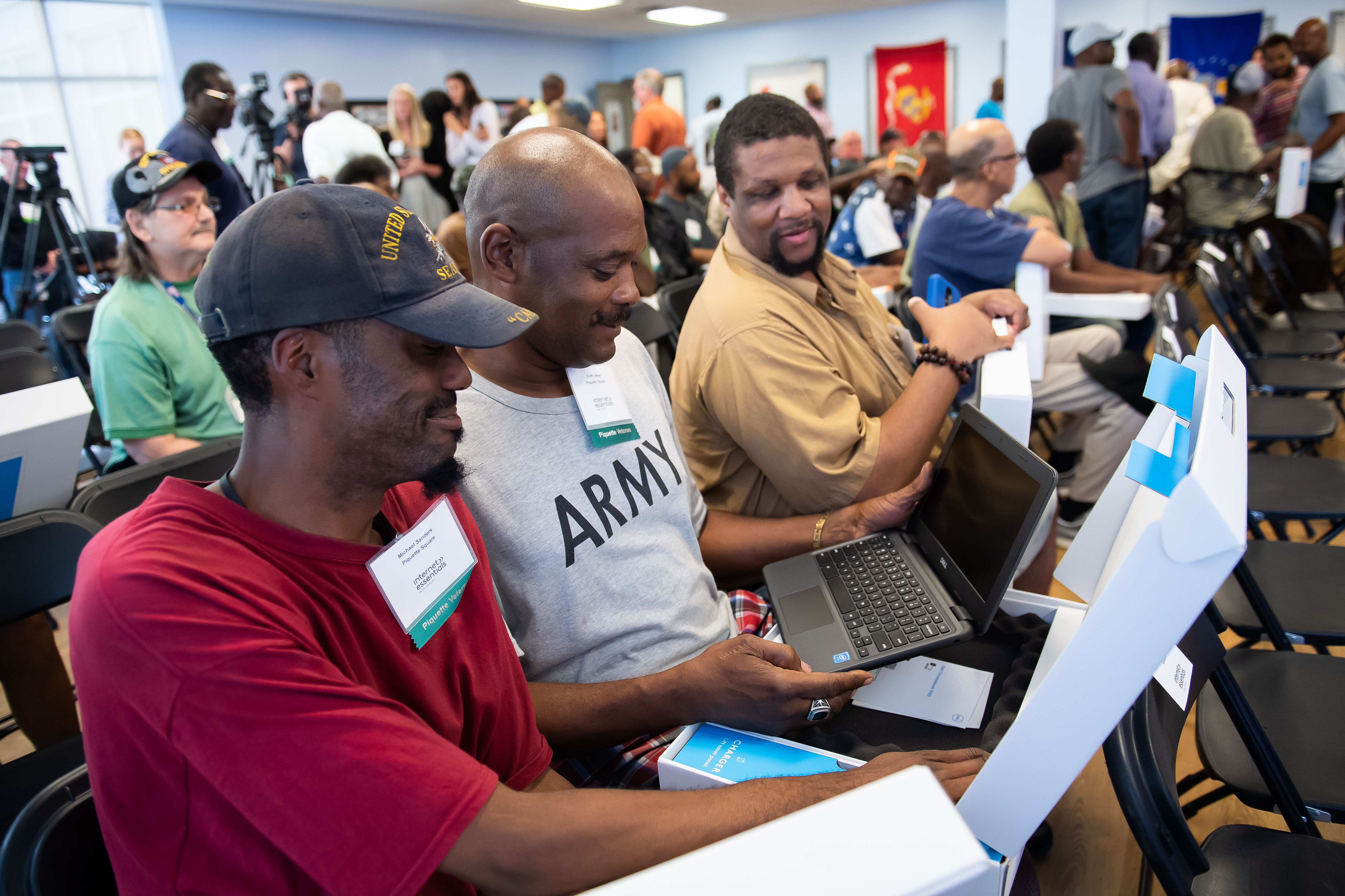 Veterans receive free laptops at an Internet Essentials event.