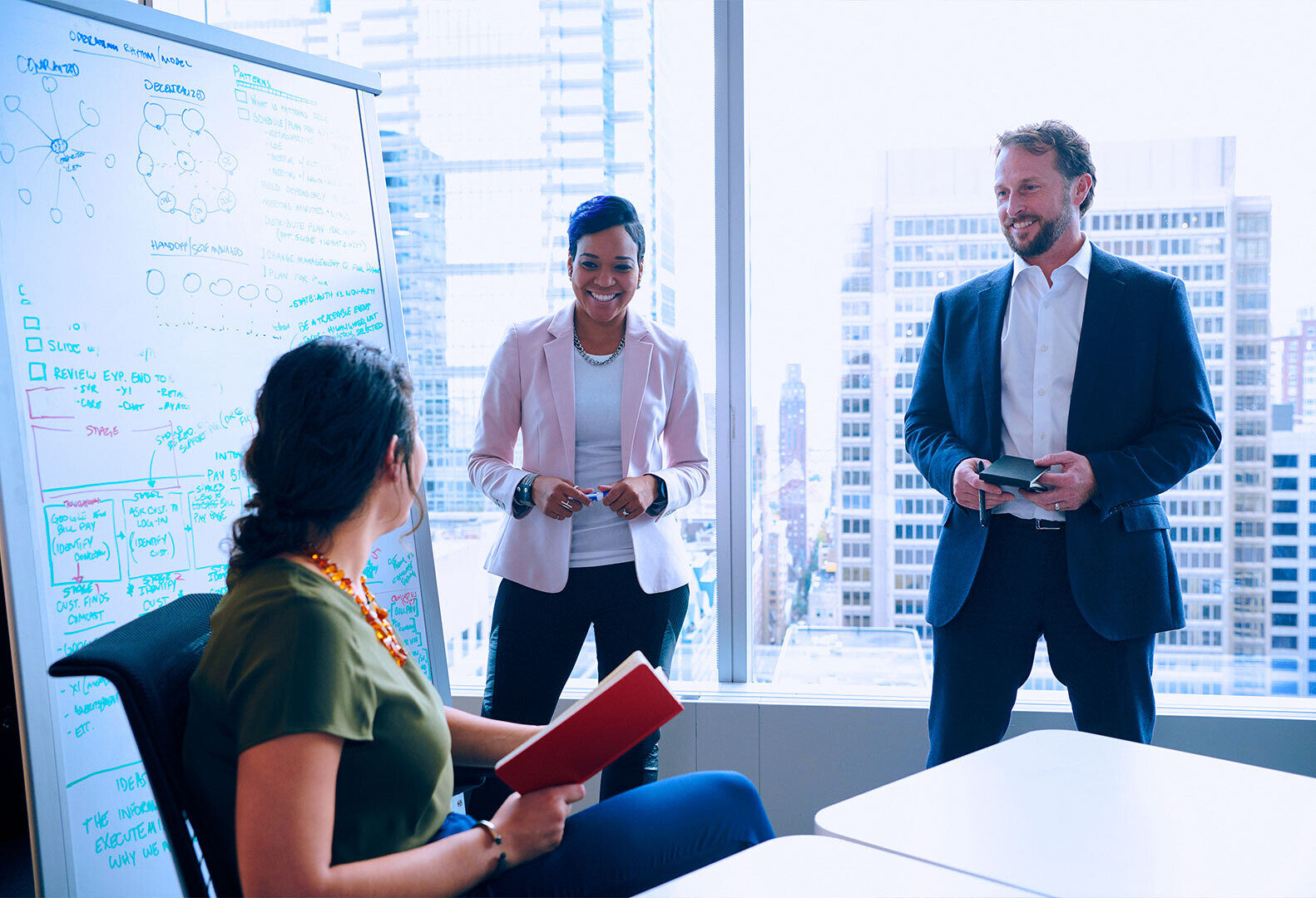 Three colleagues chat in an office