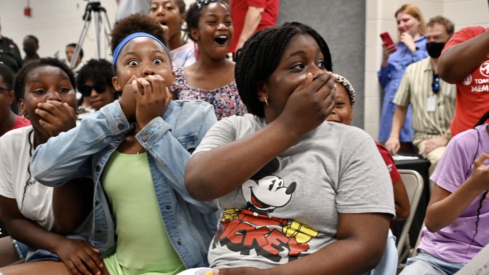 Students receive free laptops at a Project UP event.