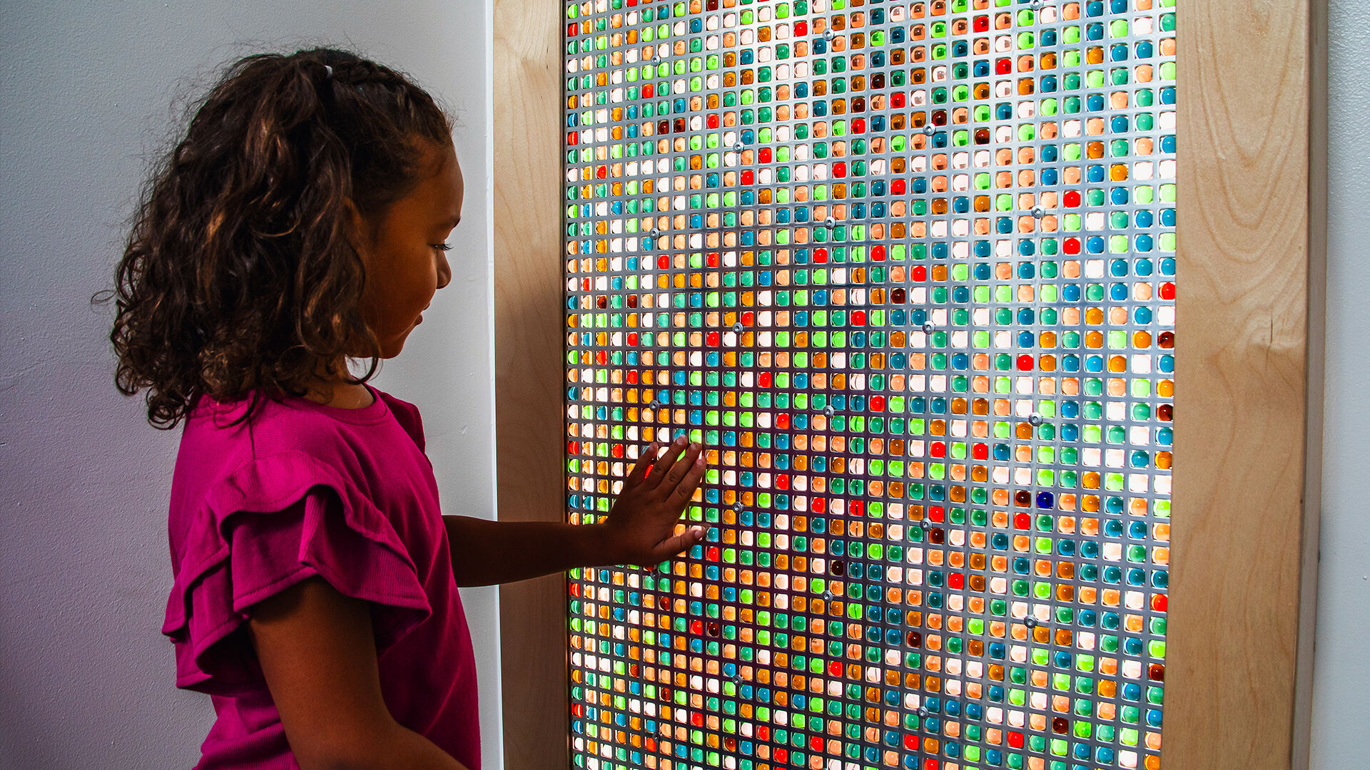 A marble wall panel —comprised of more than 2,000 marbles in a steel grid illuminated by diffused lighting — provides visual, tactile, and aural sensory input.